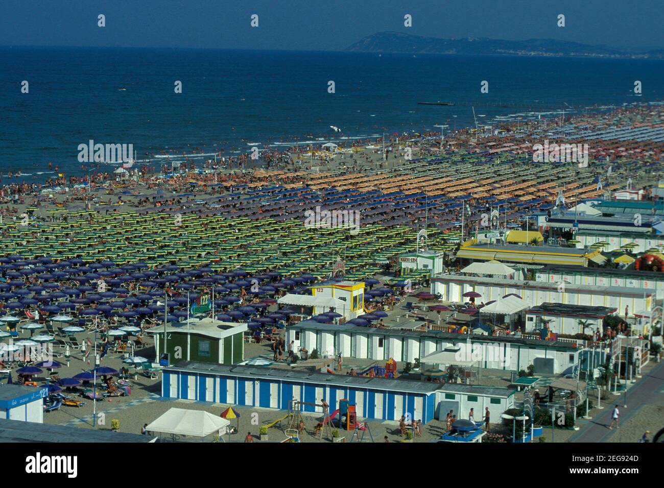 umbrellas or parasol at a public beach in Rimini in Emilia-Romagna in  Italy. Italy, Rimini, June, 2001 Stock Photo - Alamy