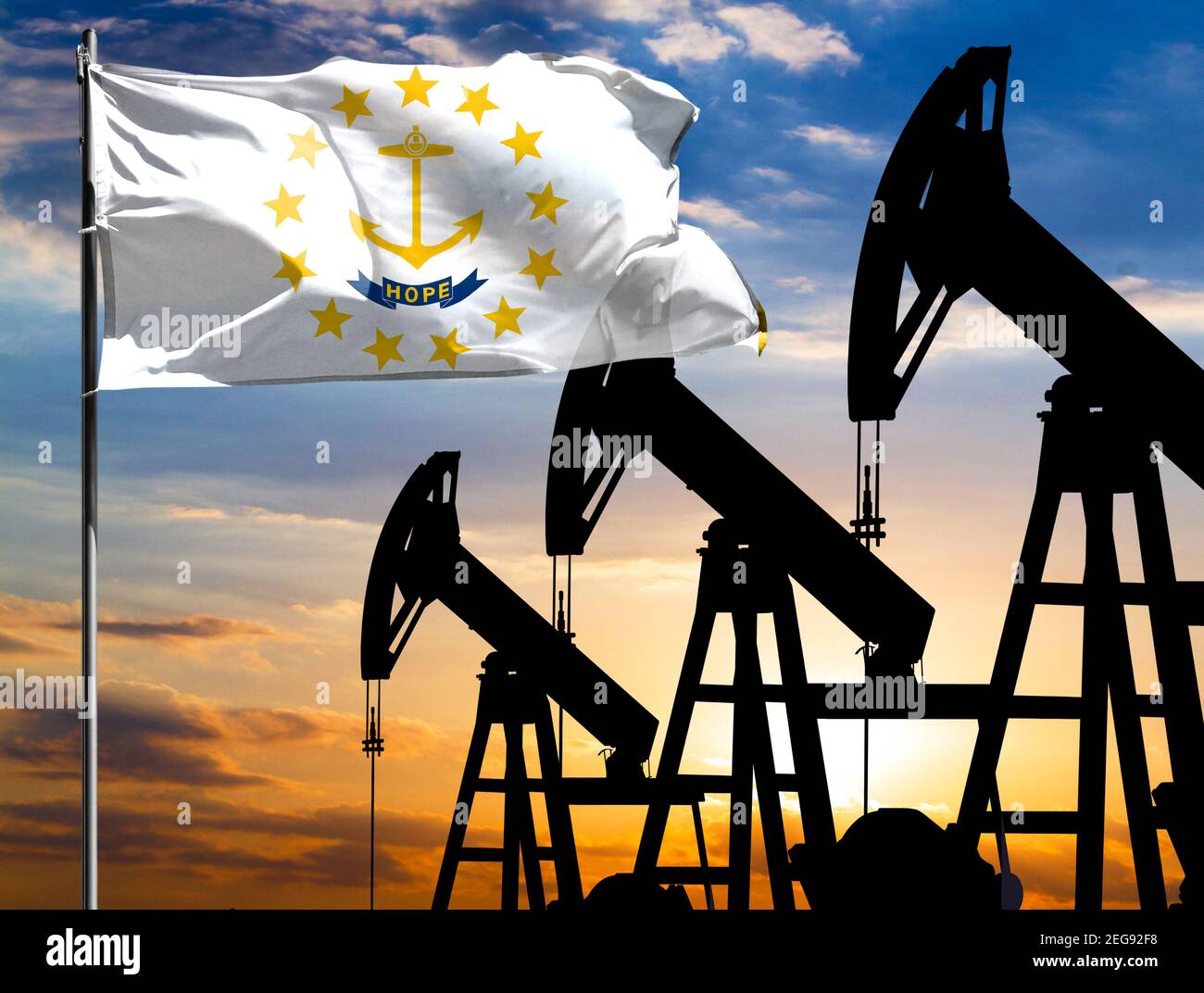 Oil rigs against the backdrop of the colorful sky and a flagpole with