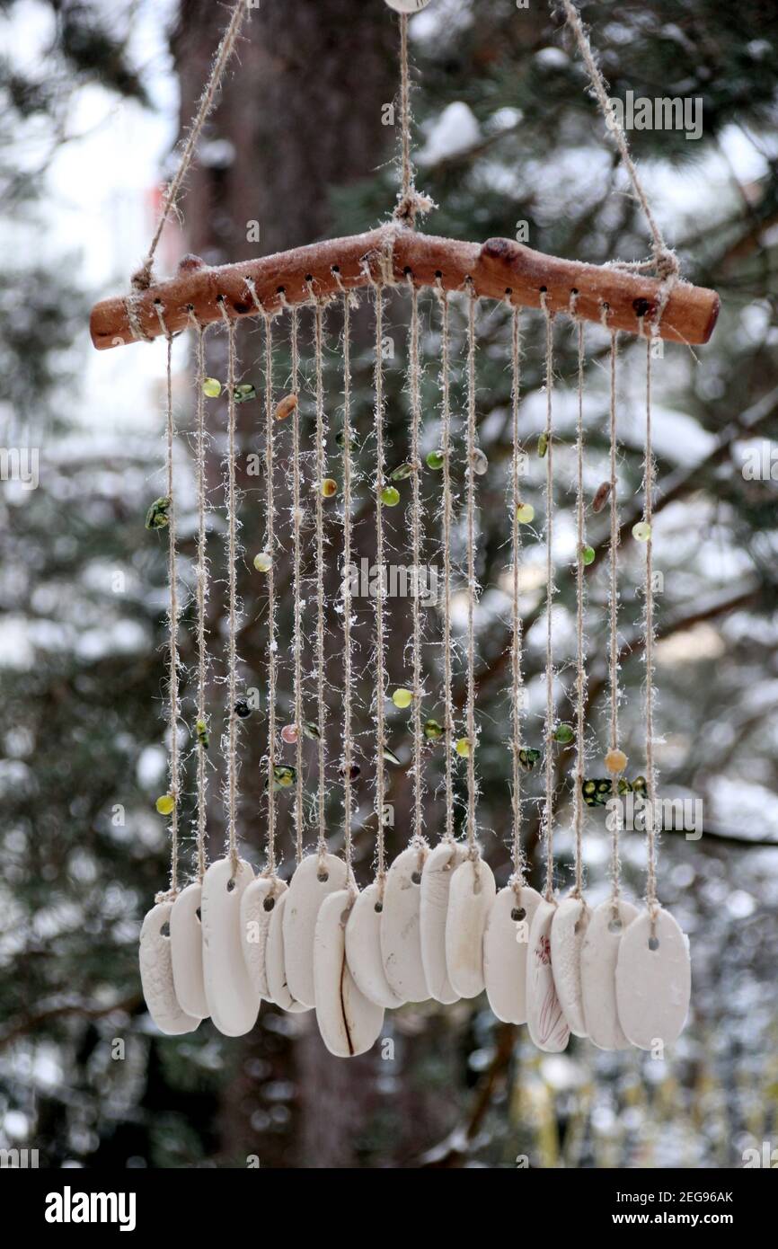 Hand made wind chimes hanging on a string with depth of field