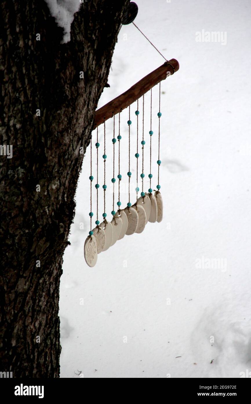 Hand made wind chimes hanging on a string with depth of field