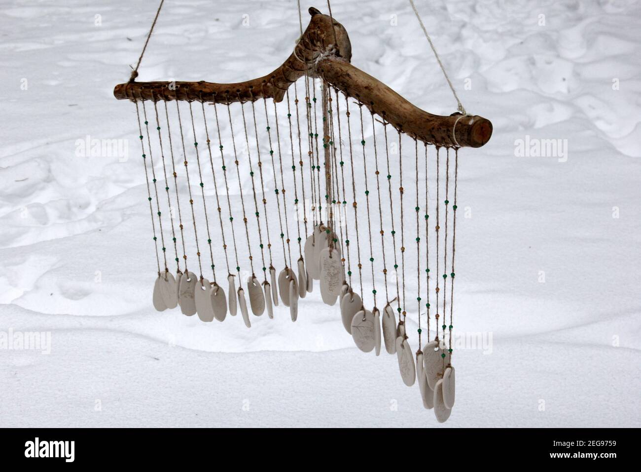 https://c8.alamy.com/comp/2EG9759/hand-made-wind-chimes-hanging-on-a-string-with-depth-of-field-effect-ceramic-wind-chime-hanging-outside-selective-focus-wind-bells-from-clay-2EG9759.jpg