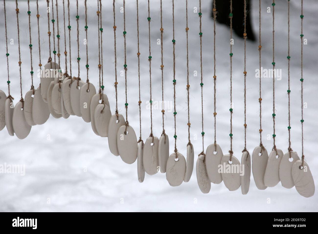 Hand made wind chimes hanging on a string with depth of field effect. Ceramic  wind chime hanging outside, selective focus, Wind bells from clay Stock  Photo - Alamy