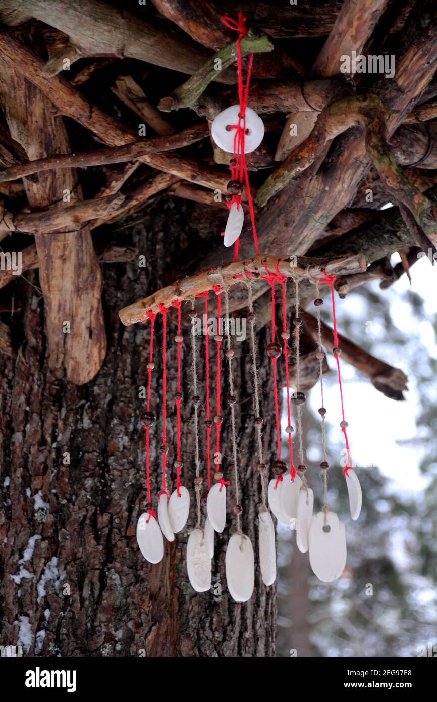 Hand made wind chimes hanging on a string with depth of field