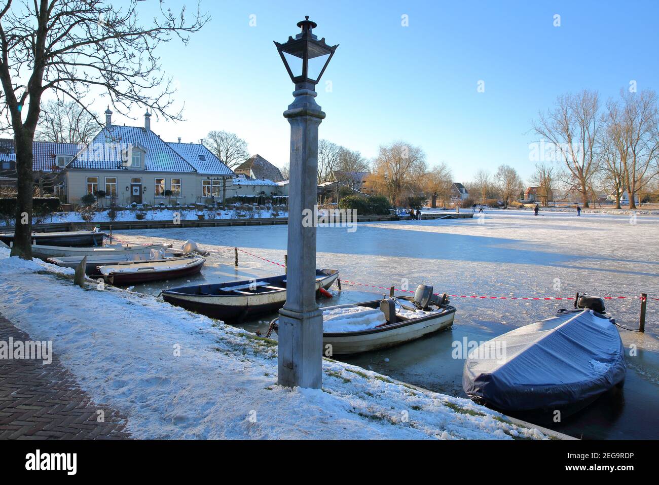Winter snow and people ice skating on frozen water in Broek in Waterland, a  small town with traditional old and painted wooden houses, North Holland  Stock Photo - Alamy