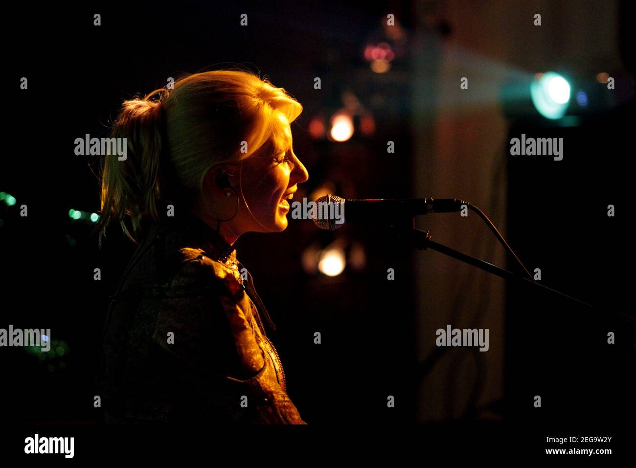Female singer performing live at an indoor concert Stock Photo Alamy