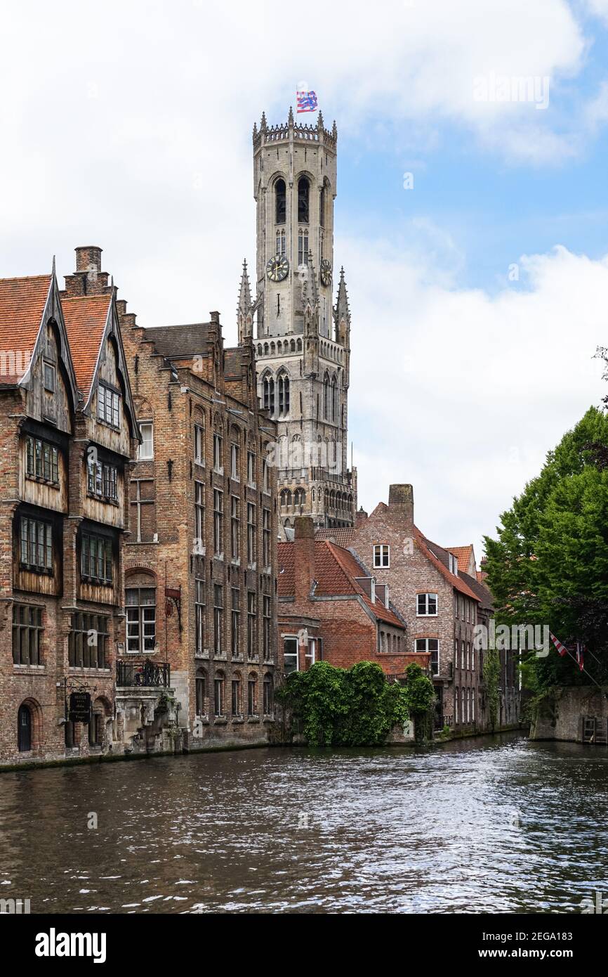 Medieval buildings on the Dijver canal with the Belfry bell tower seen from Rozenhoedkaai in Bruges, Belgium Stock Photo