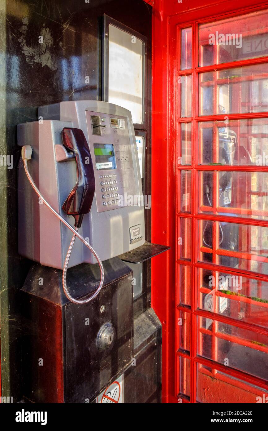 Inside red public phone box with payphone Stock Photo