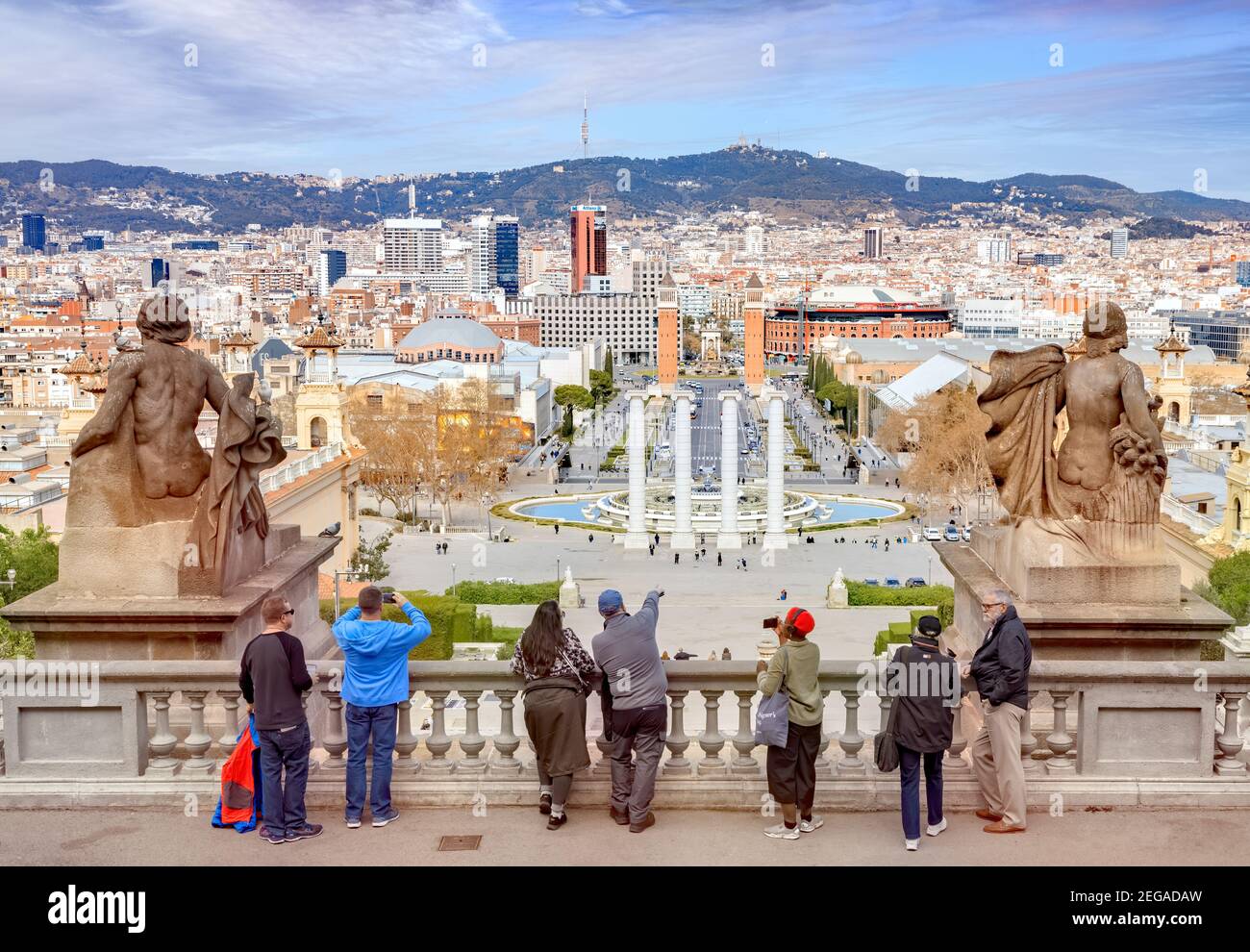 4 March 2020: Barcelona, Spain - Visitors looking over Barcelona from the National Art Museum of Catalonia towards Plaça d'Espanya and Mount Tibidabo. Stock Photo