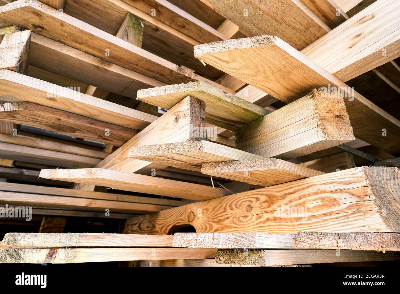 Stacked plates of wood in warehouse for buildings construction