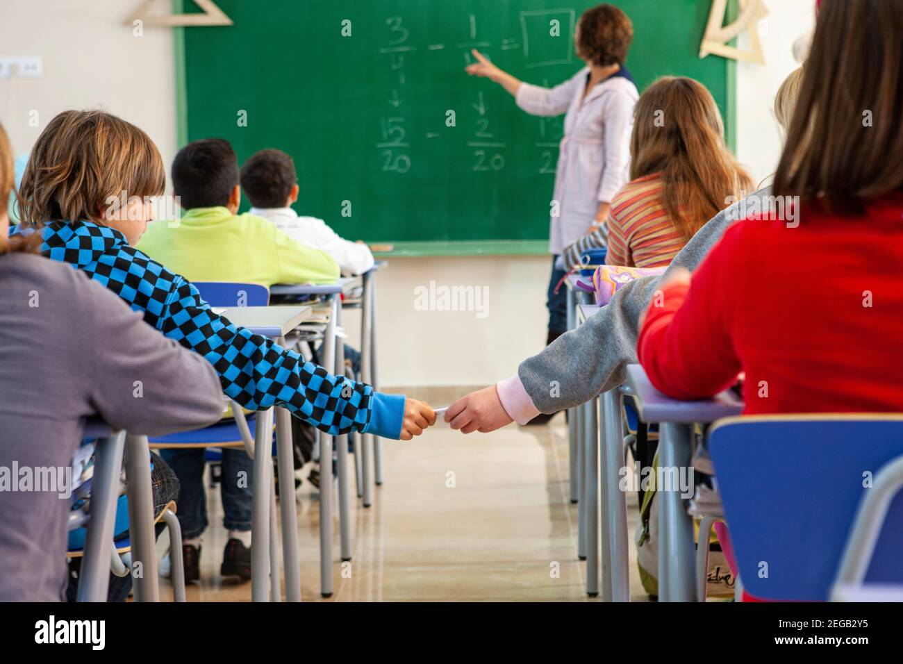 Teacher teaching her class in a school classroom Stock Photo