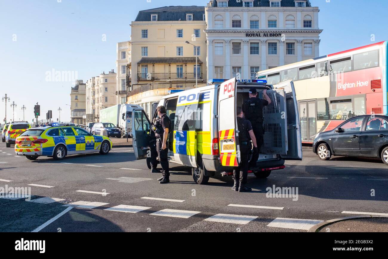 Brighton UK 18th February 2021 - Police officers close off Brighton seafront after pulling over a car causing major traffic congestion in the city . Two men have been arrested after the car had been spotted driving erratically through Sussex before being stopped by Brighton Palace Pier : Credit Simon Dack / Alamy Live News Stock Photo