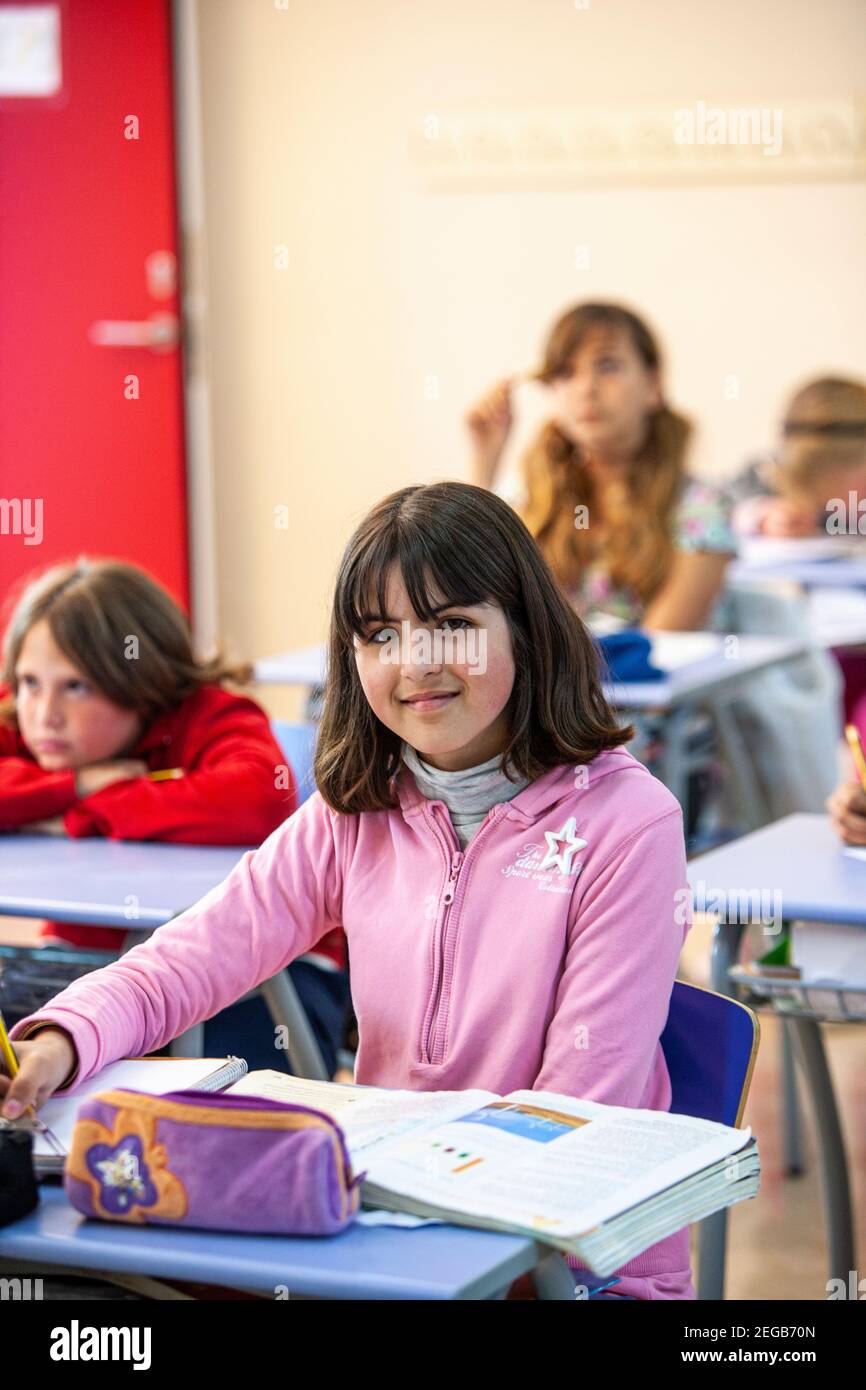 Young girl studying in a school classroom Stock Photo - Alamy