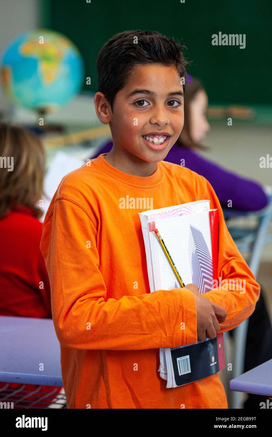 Happy young boy in a school classroom Stock Photo