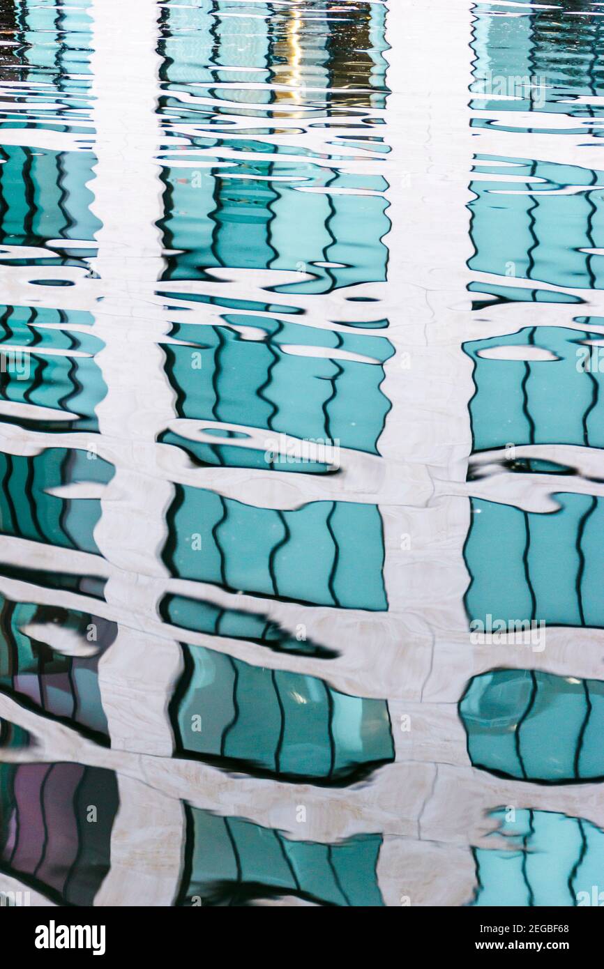 Abstract composition of rippling reflection of an apartment block in the water of Regent's Canal in Islington, London, UK Stock Photo