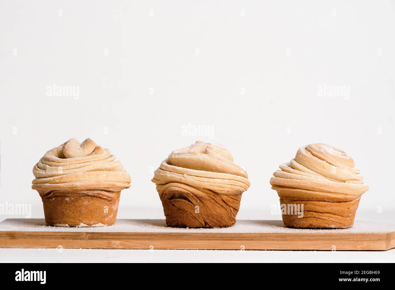cruffins easter spring pastries, a mix of muffin and croissant on a light background, close-up for text place. Stock Photo