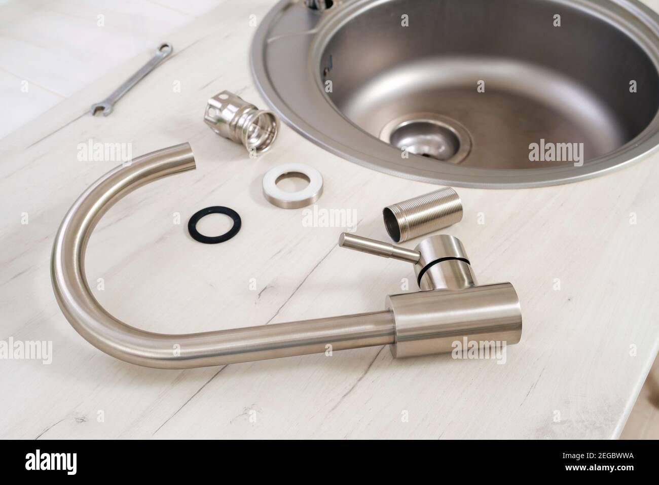 New faucet and tools for installing into the kitchen sink Stock Photo