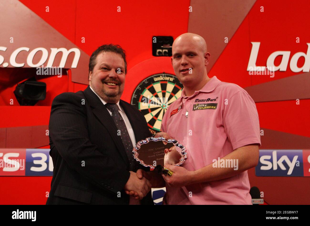 Darts - 2011 Ladbrokes.com World Darts Championship - Alexandra Palace,  London - 3/1/11 Peter Manley, Chairman of Professional Darts Players  Association presents Michael van Gerwen with runners up trophy after the PDC