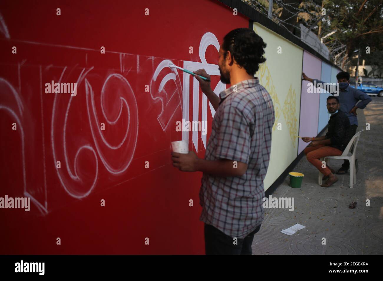 Dhaka, Bangladesh. 18th Feb, 2021. Artists are painting the walls with