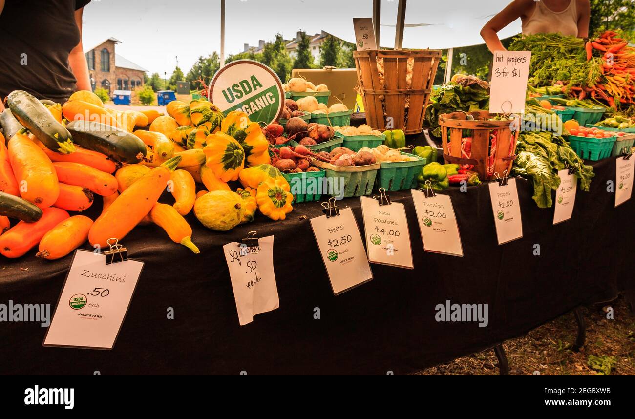Lots of colorful, inviting, fresh organic produce stand at local farmer's market. Stock Photo