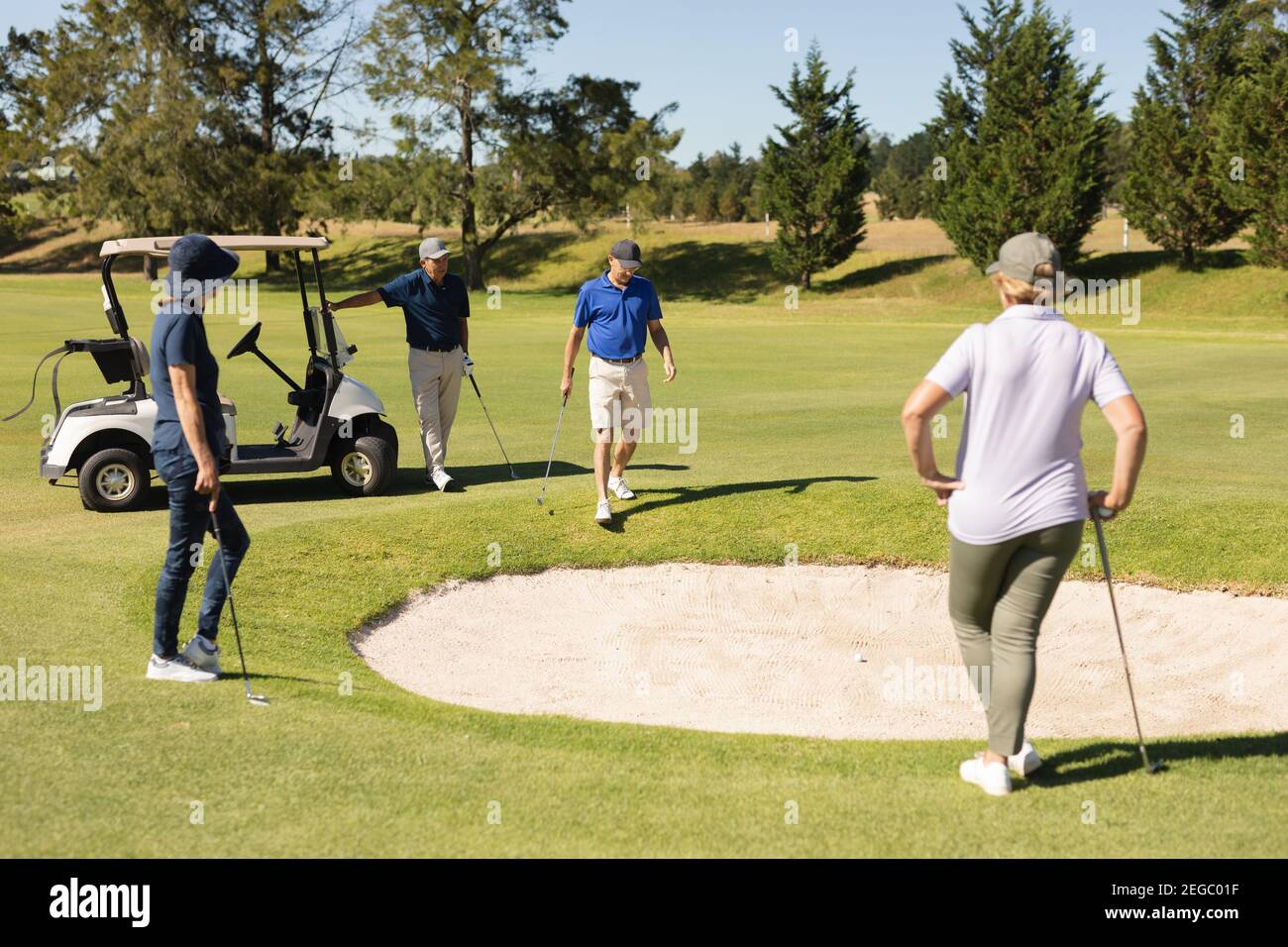 Four caucasian senior men and women gathering around the bunker Stock Photo