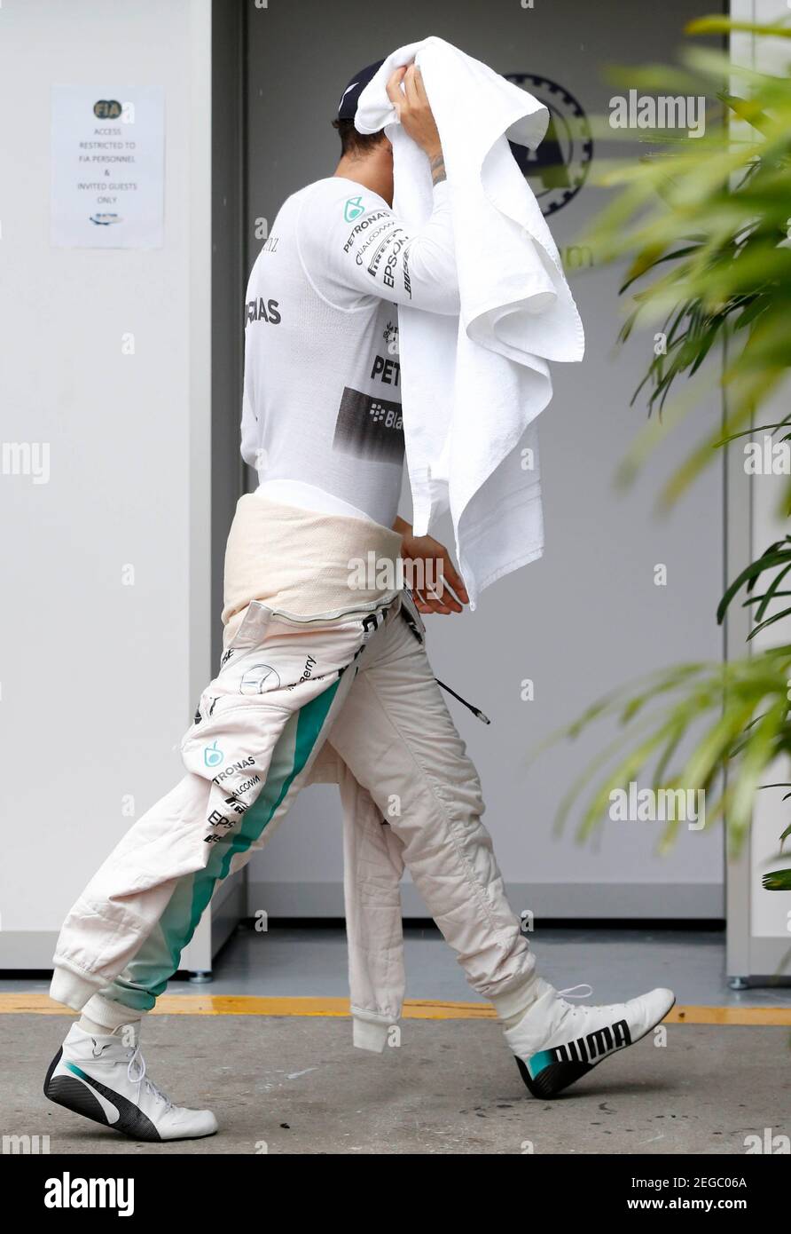 Formula One - F1 - Malaysian Grand Prix 2015 - Sepang International Circuit, Kuala Lumpur, Malaysia - 28/3/15  Mercedes' Lewis Hamilton covers his head with a towel after qualifying was halted due to rain  Reuters / Olivia Harris  Livepic Stock Photo