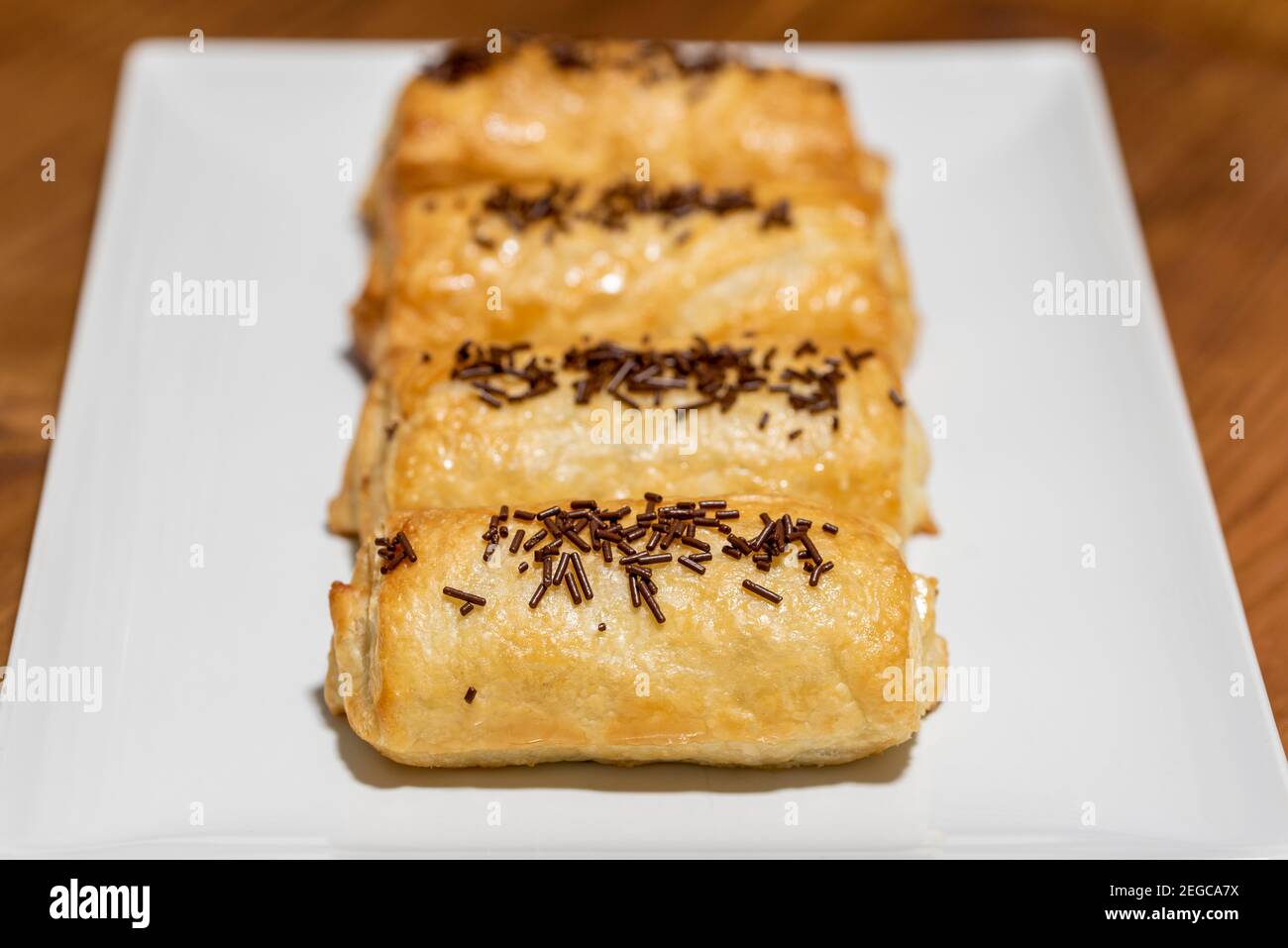 pain au chocolat  in plate on a wooden dark background Stock Photo