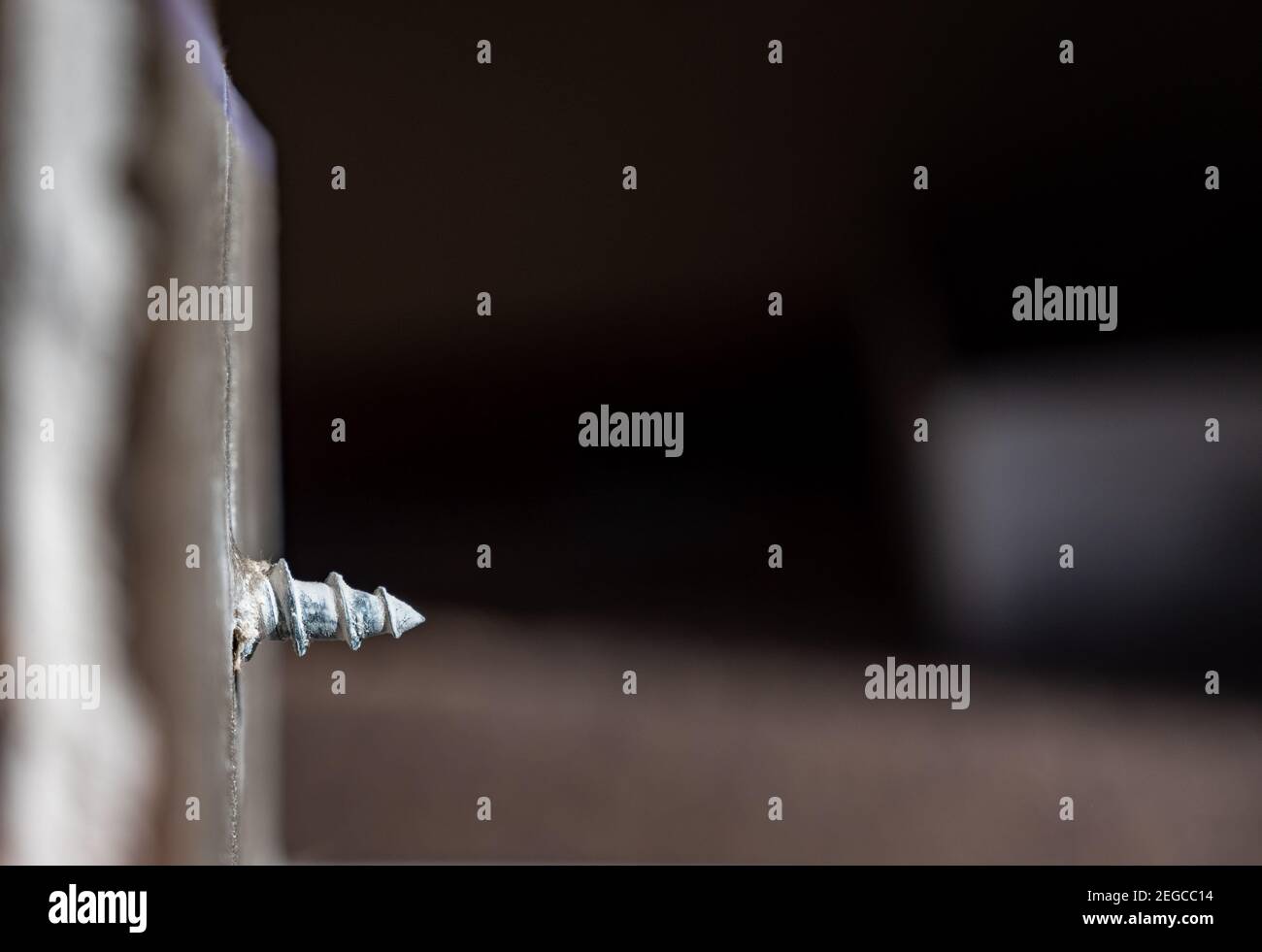 Side view of a drywall mount anchor and screw for hanging objects on