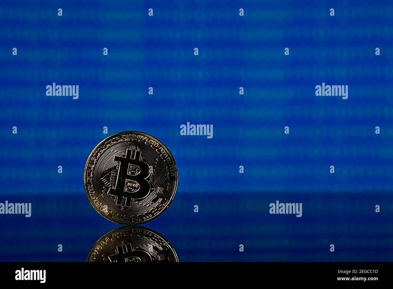 Golden bitcoin, binary code on a blue background Stock Photo