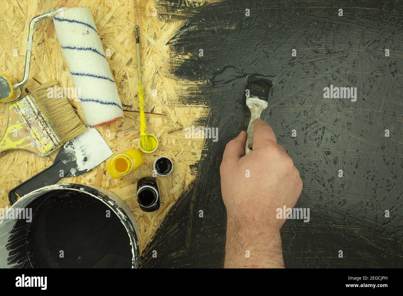 The painter mixes paint and water emulsion. Selection of paint color