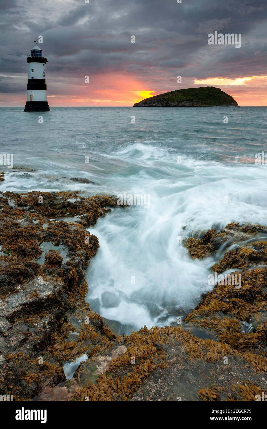 Penmon Point lighthouse and Puffin Island at dawn, Anglesey, North Wales Stock Photo