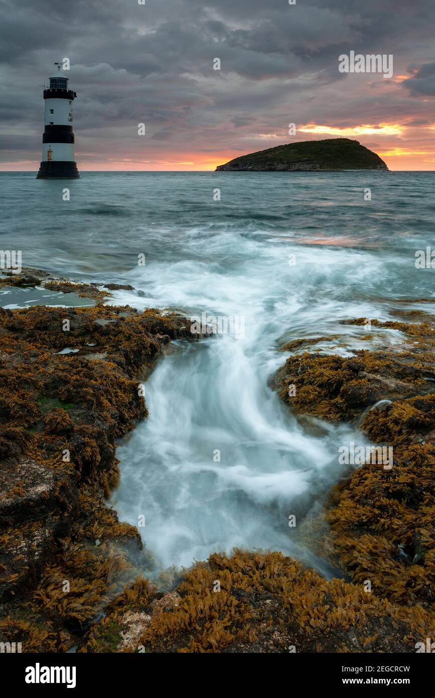 Penmon Point lighthouse and Puffin Island at dawn, Anglesey, North Wales Stock Photo