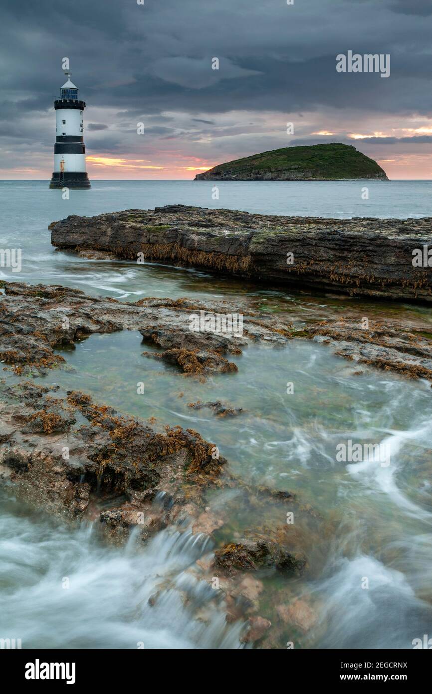 Penmon Point lighthouse and Puffin Island at dawn, Anglesey, North Wales Stock Photo