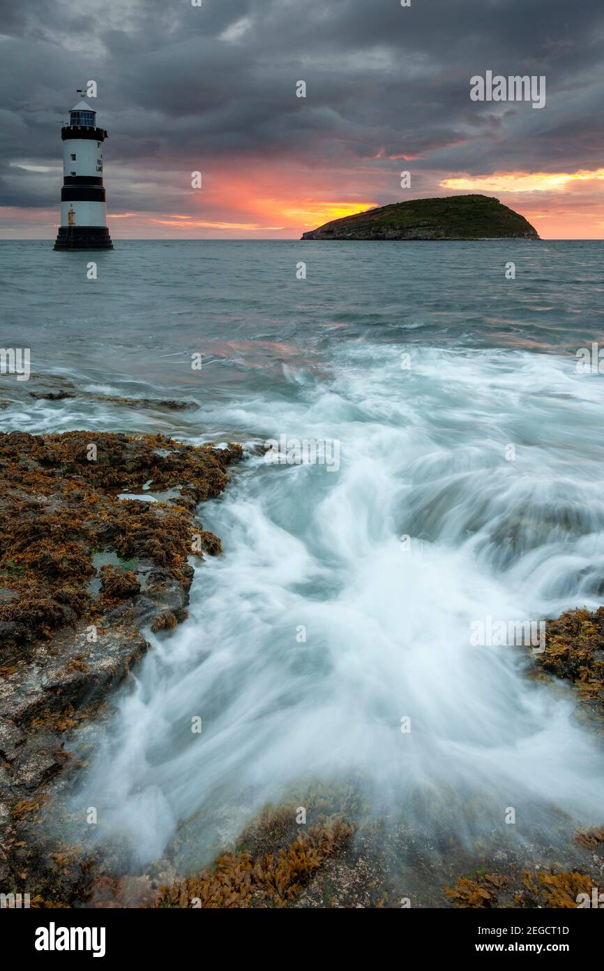 Penmon Point lighthouse and Puffin Island at dawn, Anglesey, North Wales Stock Photo