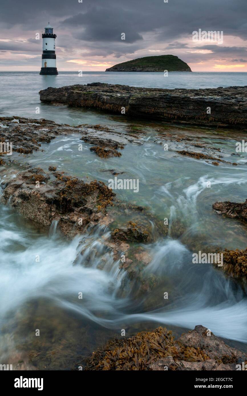 Penmon Point lighthouse and Puffin Island at dawn, Anglesey, North Wales Stock Photo