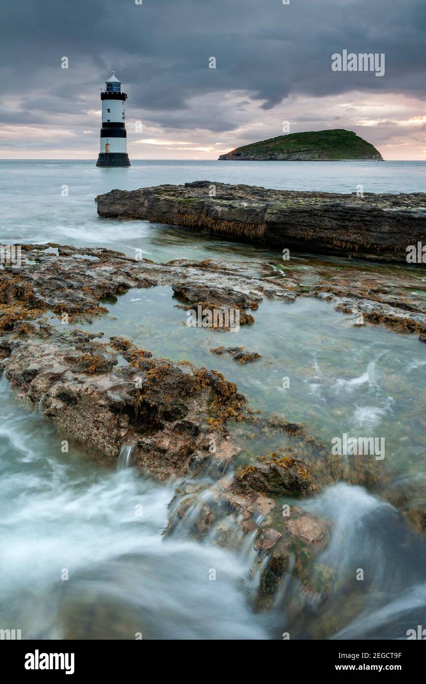 Penmon Point lighthouse and Puffin Island at dawn, Anglesey, North Wales Stock Photo