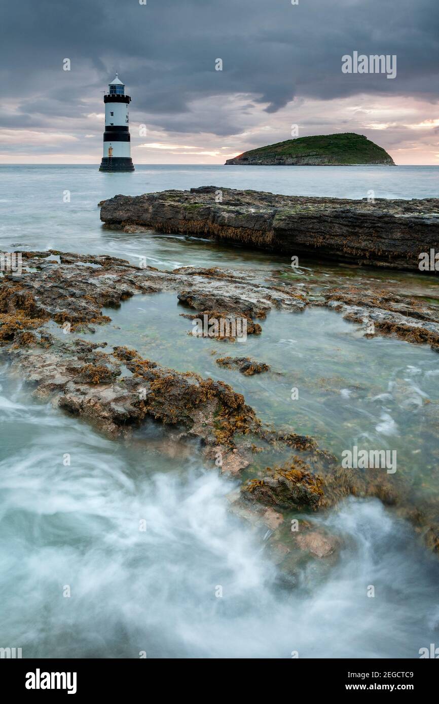 Penmon Point lighthouse and Puffin Island at dawn, Anglesey, North Wales Stock Photo