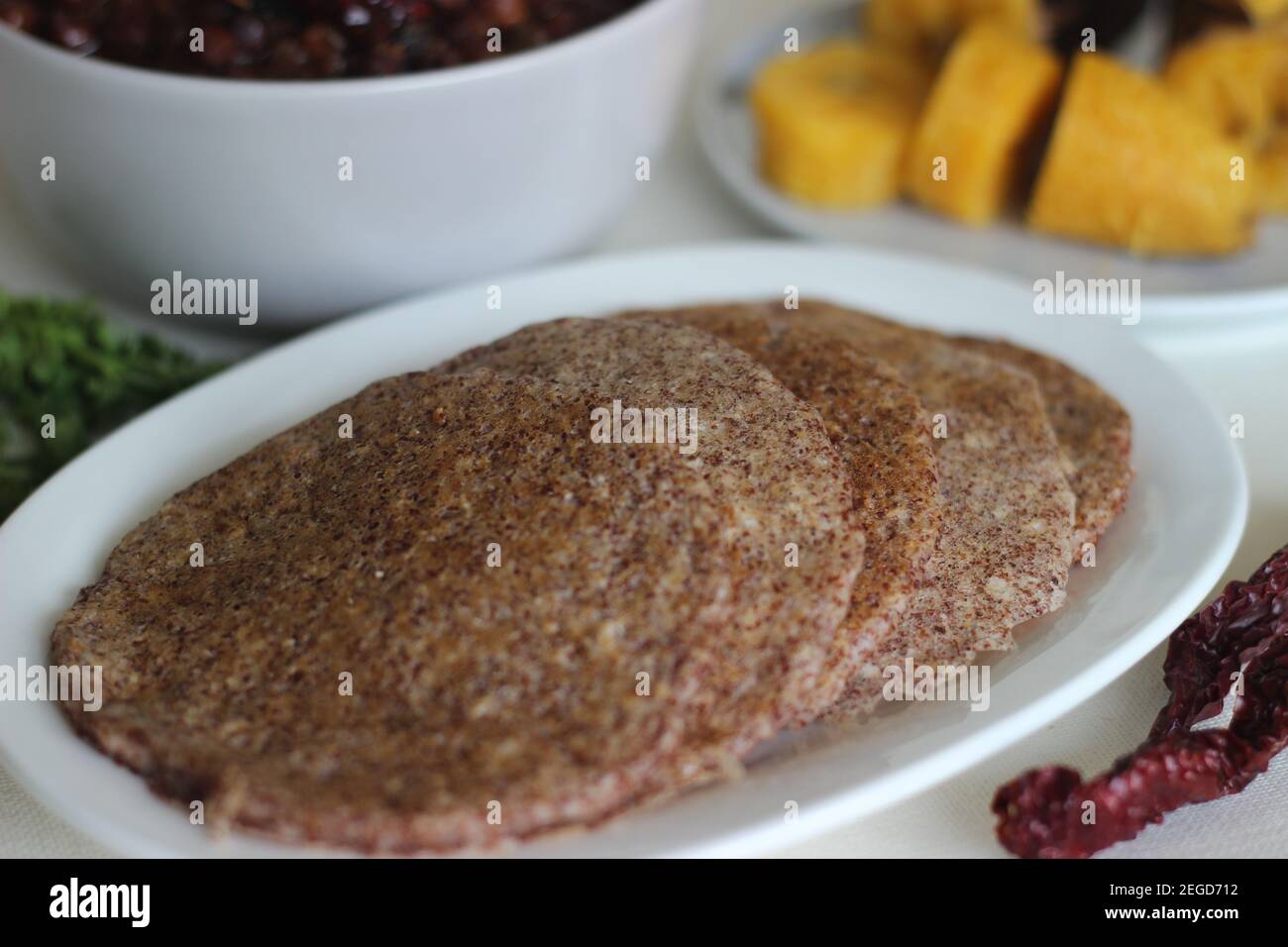 Home made Finger millet pancakes served with black chickpea gravy and