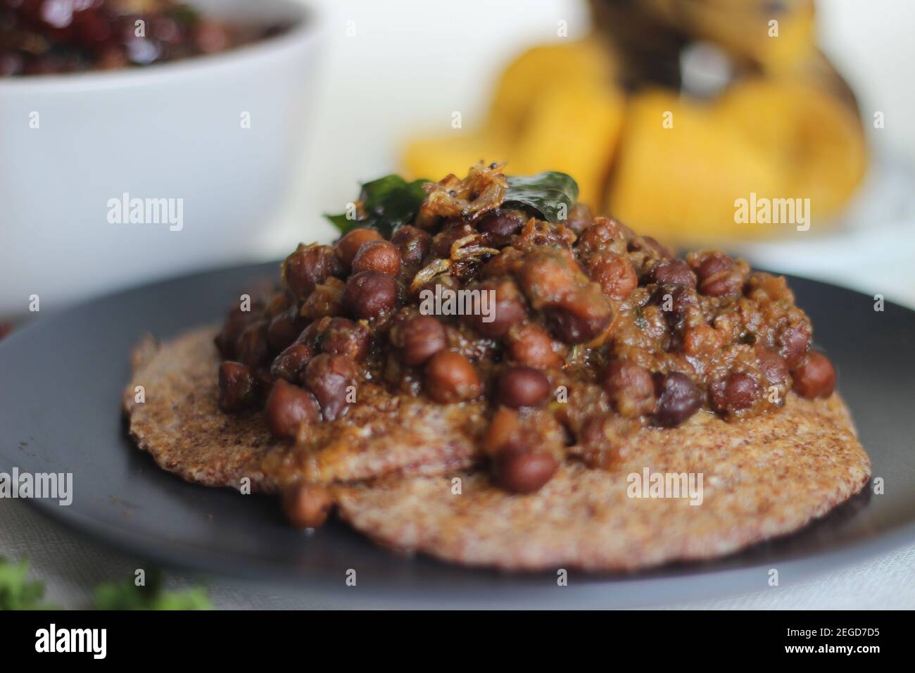 Home made Finger millet pancakes served with black chickpea gravy and