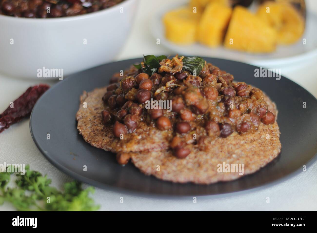 Home made Finger millet pancakes served with black chickpea gravy and