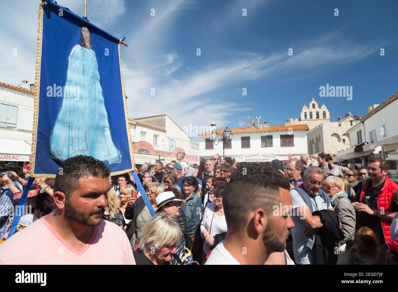 Roma and other participants accompany the statue of the Gypsy Patron Saint Sarah in the annual procession through the streets of Saintes-Maries-de-la- Stock Photo