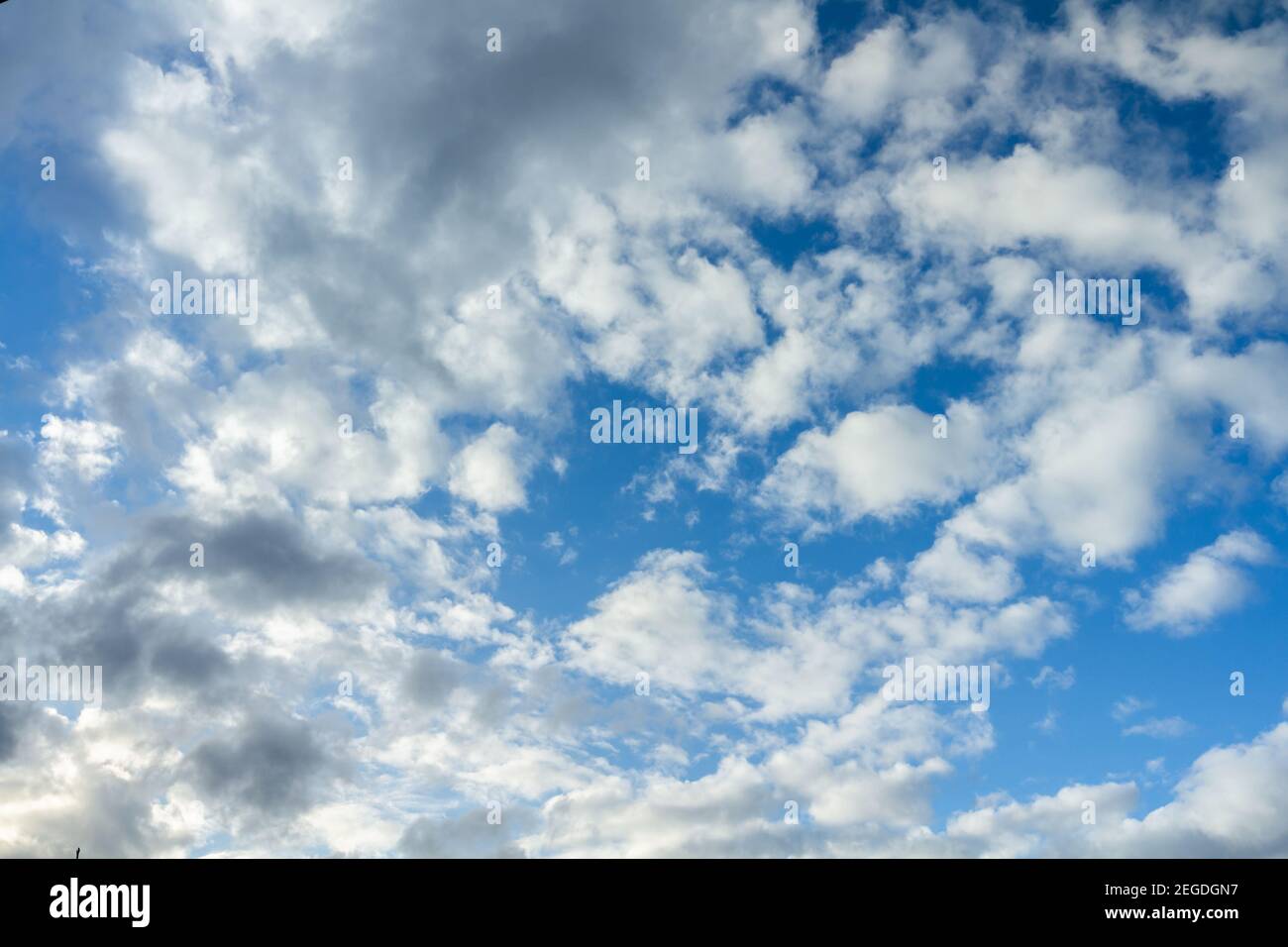 Clouds moving on blue sky forming a storm. Stock Photo
