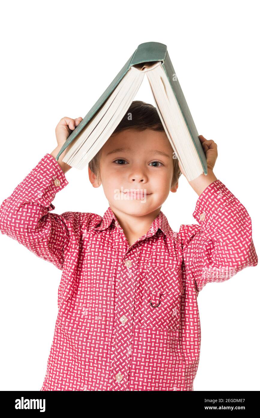 Young boy holding book over head like roof, isolated over white ...