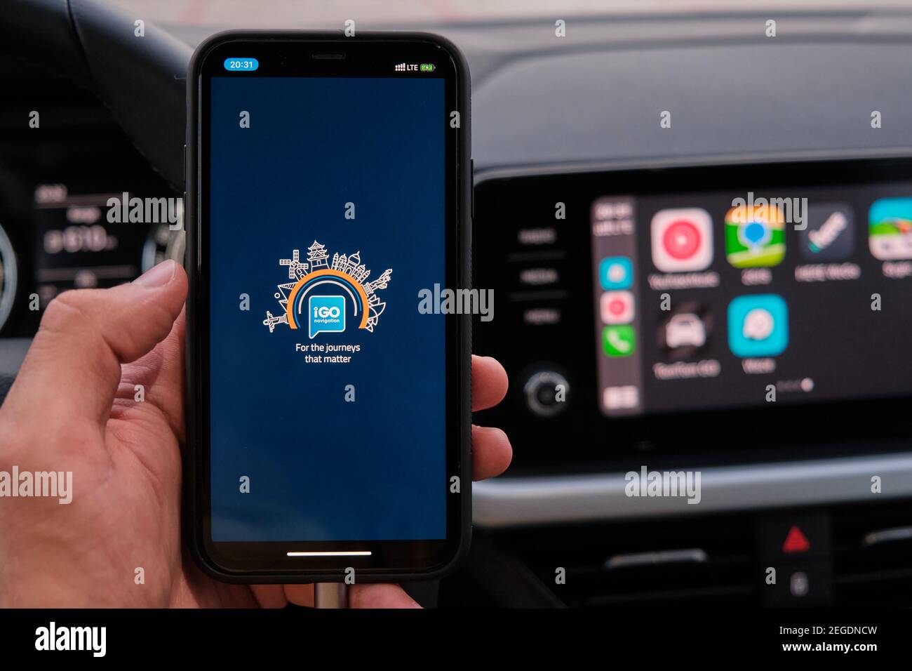 IGO logo on the screen of smart phone in mans hand on the background of car  dashboard screen with application of navigation or maps. January 2021 Stock  Photo - Alamy
