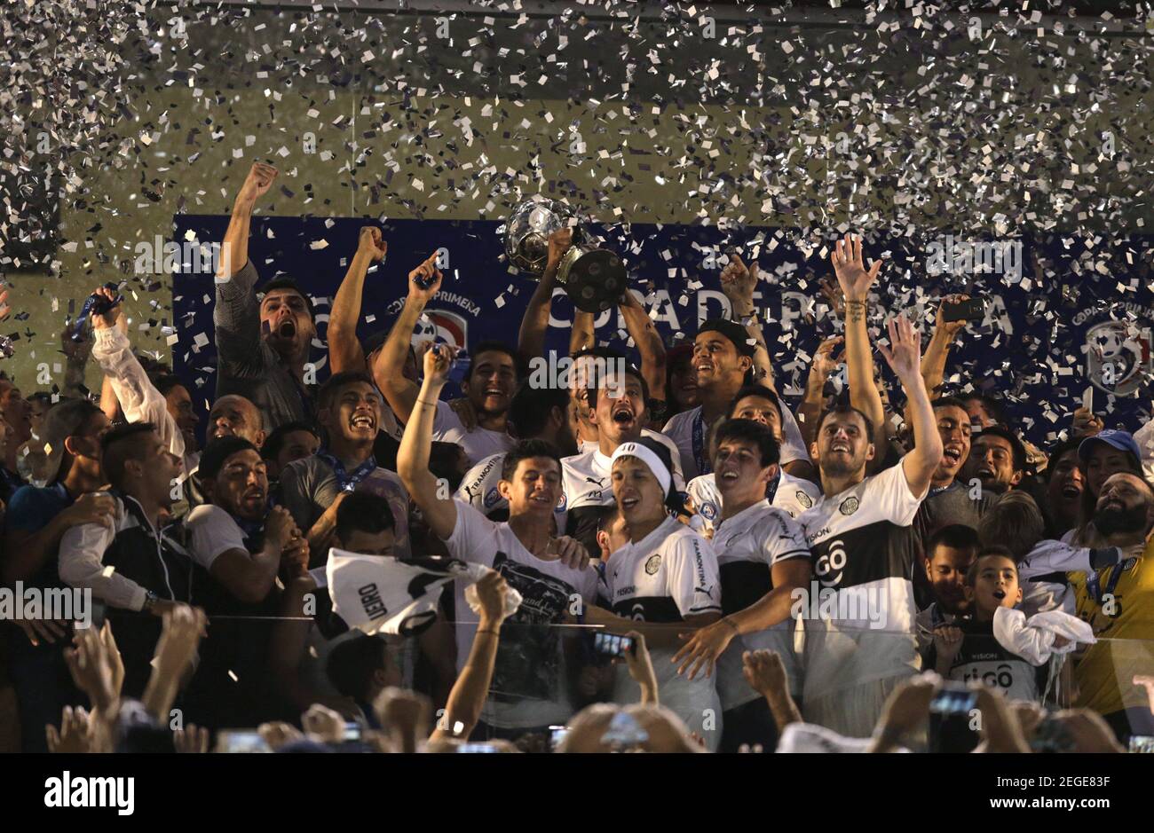 Olimpia's players celebrate with the trophy after winning the Paraguayan championship against Cerro Porteno at the Defensores del Chaco stadium in Asuncion December 9, 2015. REUTERS/Jorge Adorno    Picture Supplied by Action Images Stock Photo