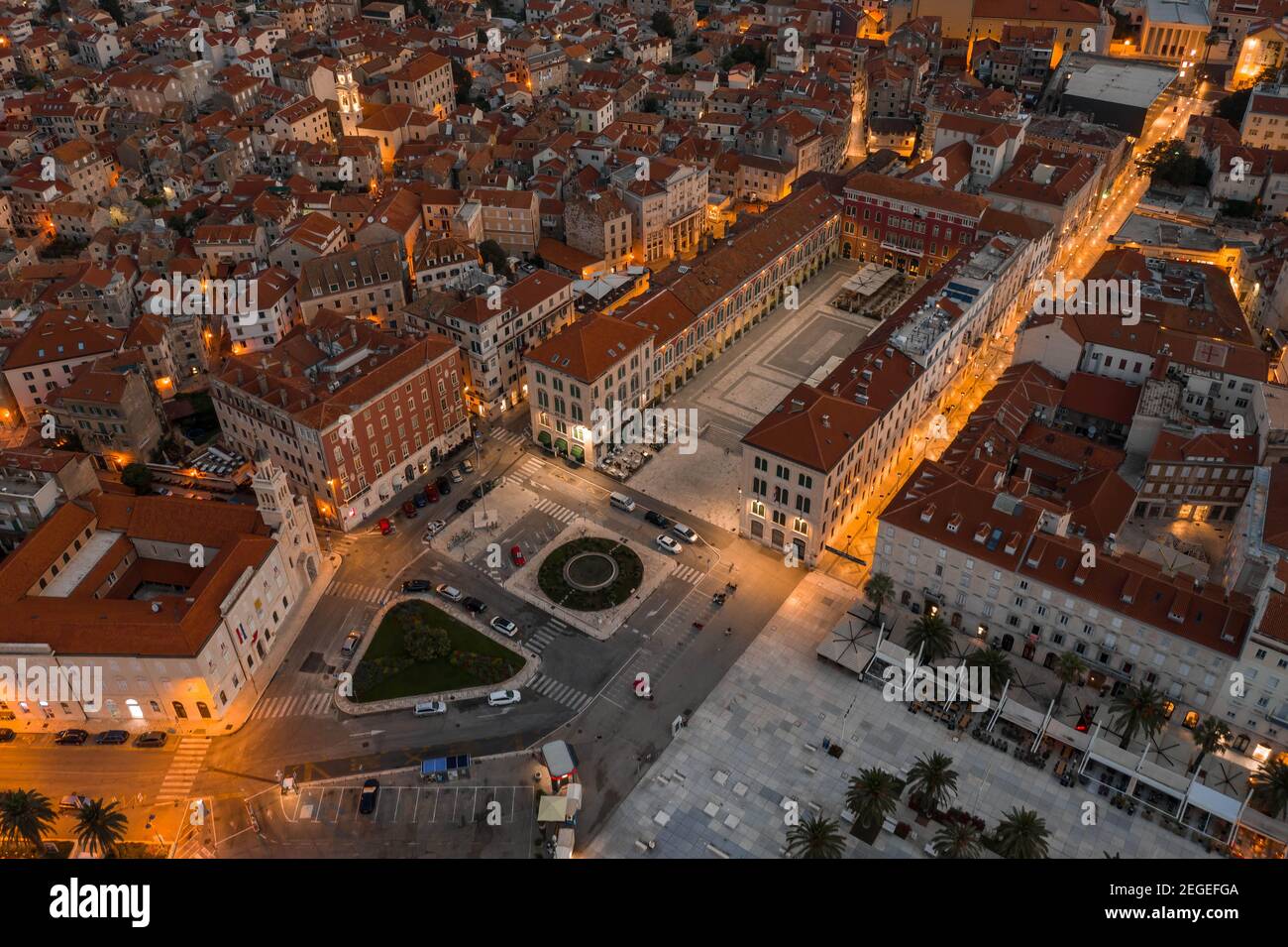 Aerial drone shot of empty republic square by riva with light at dusk in Split old town before sunrise in Croatia Stock Photo