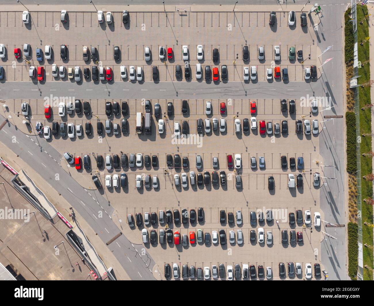 Aerial top down view to parking full of cars with isolated red cars Stock Photo
