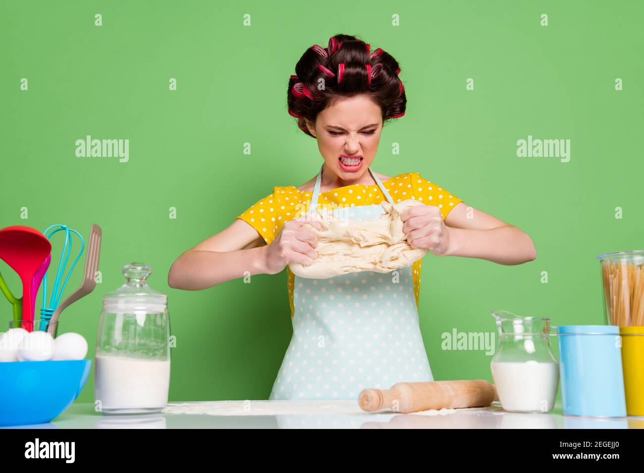 Portrait of her she nice attractive glamorous crazy evil mad wife wearing curlers kneading dough making italian pizza hard difficult bakery isolated Stock Photo