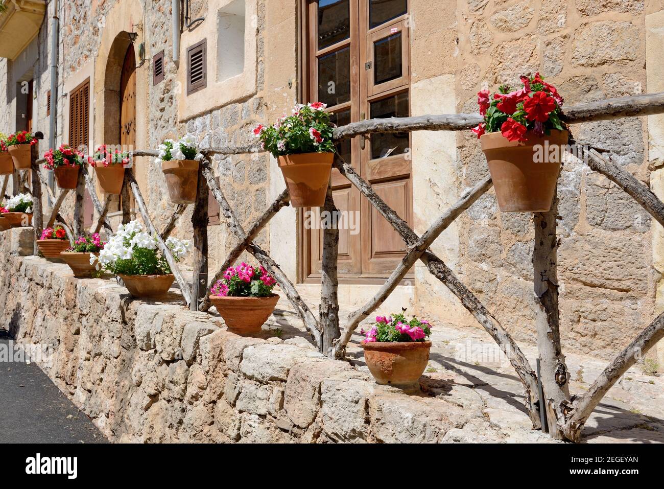 The decoration of building with outdoor pot flowers on wooden fence in ...