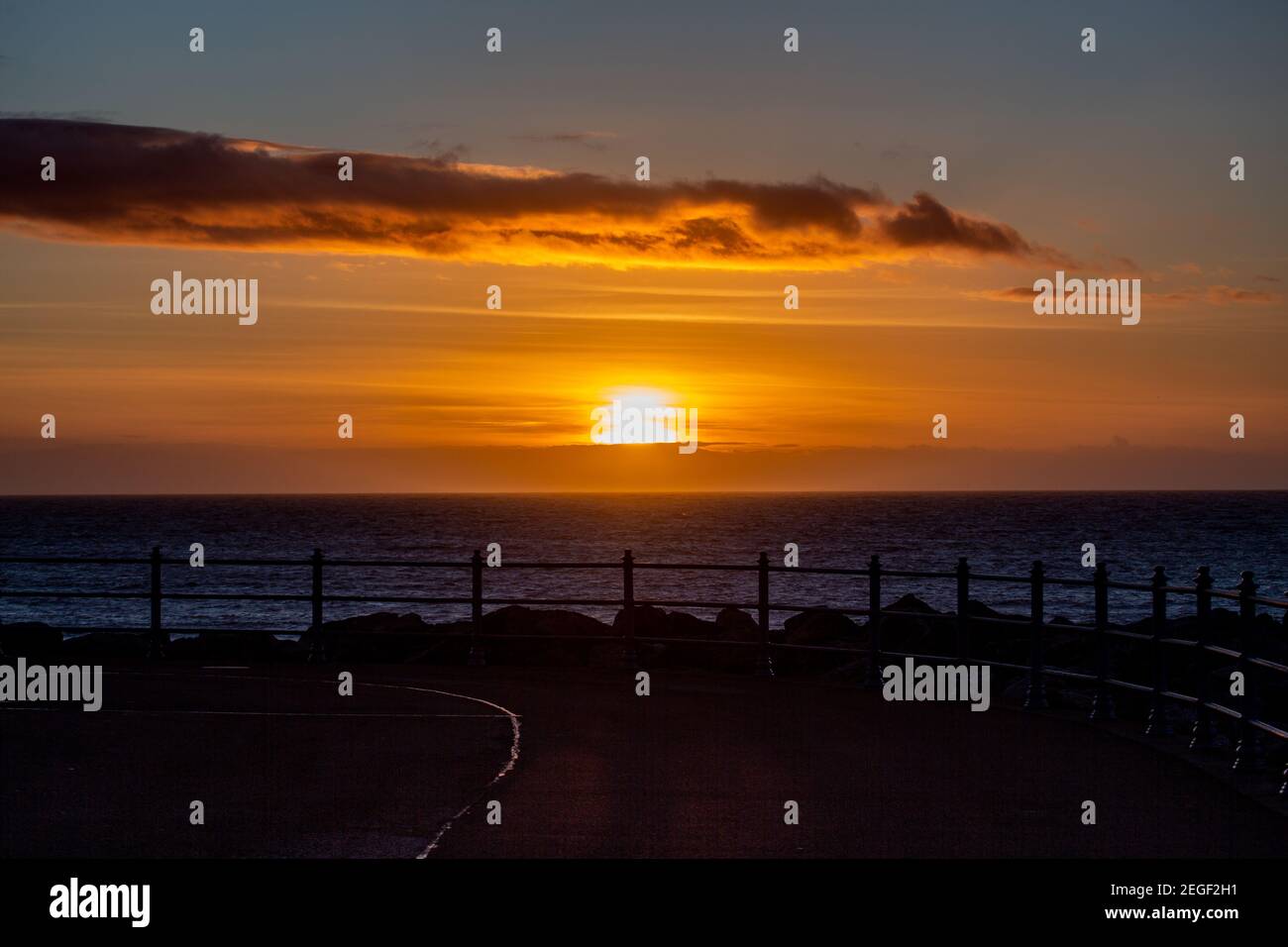 Morecambe, Lancashire, United Kingdom. 18th Feb, 2021. Sun about to disappear behind a bank of cloud as it sets this after noon over the Irish Sea Credit: PN News/Alamy Live News Stock Photo