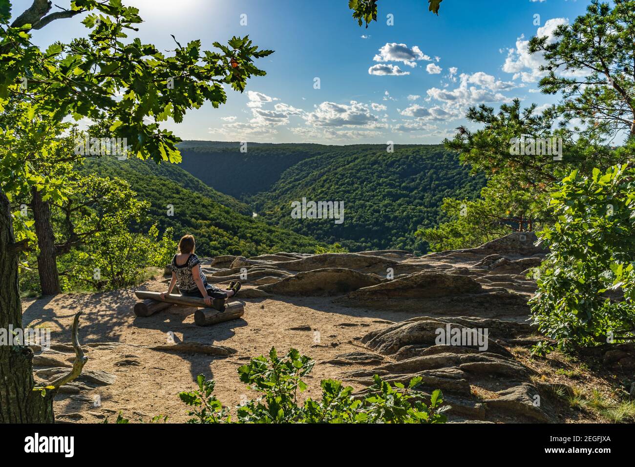 A girl is sitting and enjoying the view of the National Park Podyji in the South Moravian Region of the Czech Republic. Stock Photo